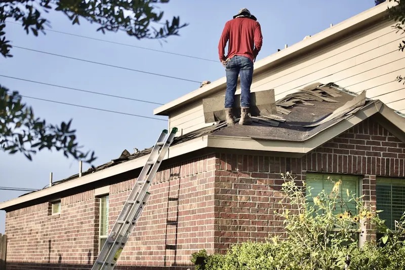 Professional roofer working on a residential roof in Dania Beach